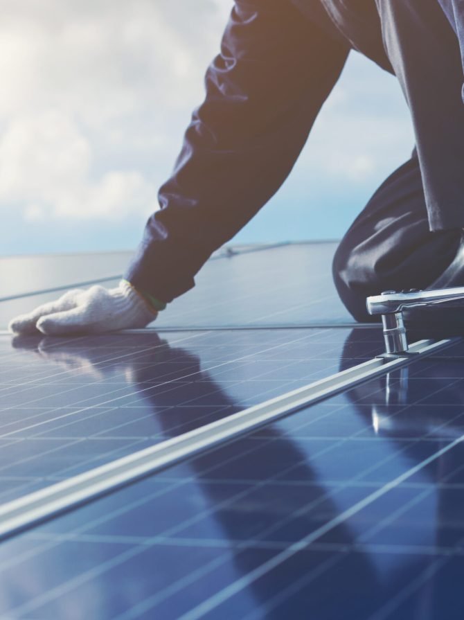 engineers repairing solar panel at generating power of solar power plant ; technician in industry uniform on level of job description at industrial